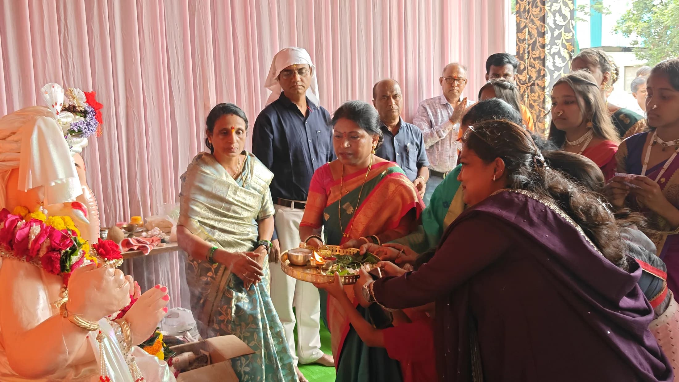 School community gathered near the Ganpati altar