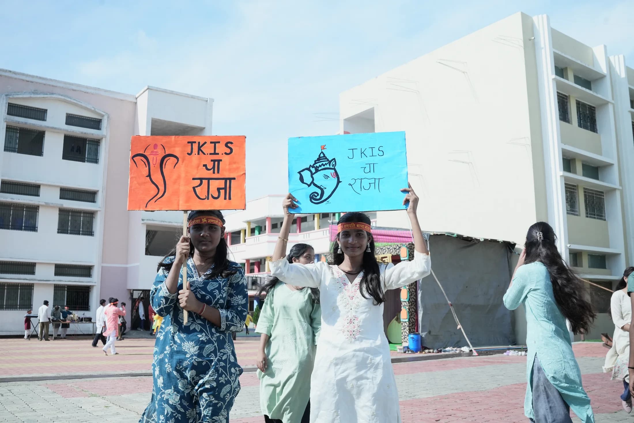 Students holding Ganpati welcome placards on campus