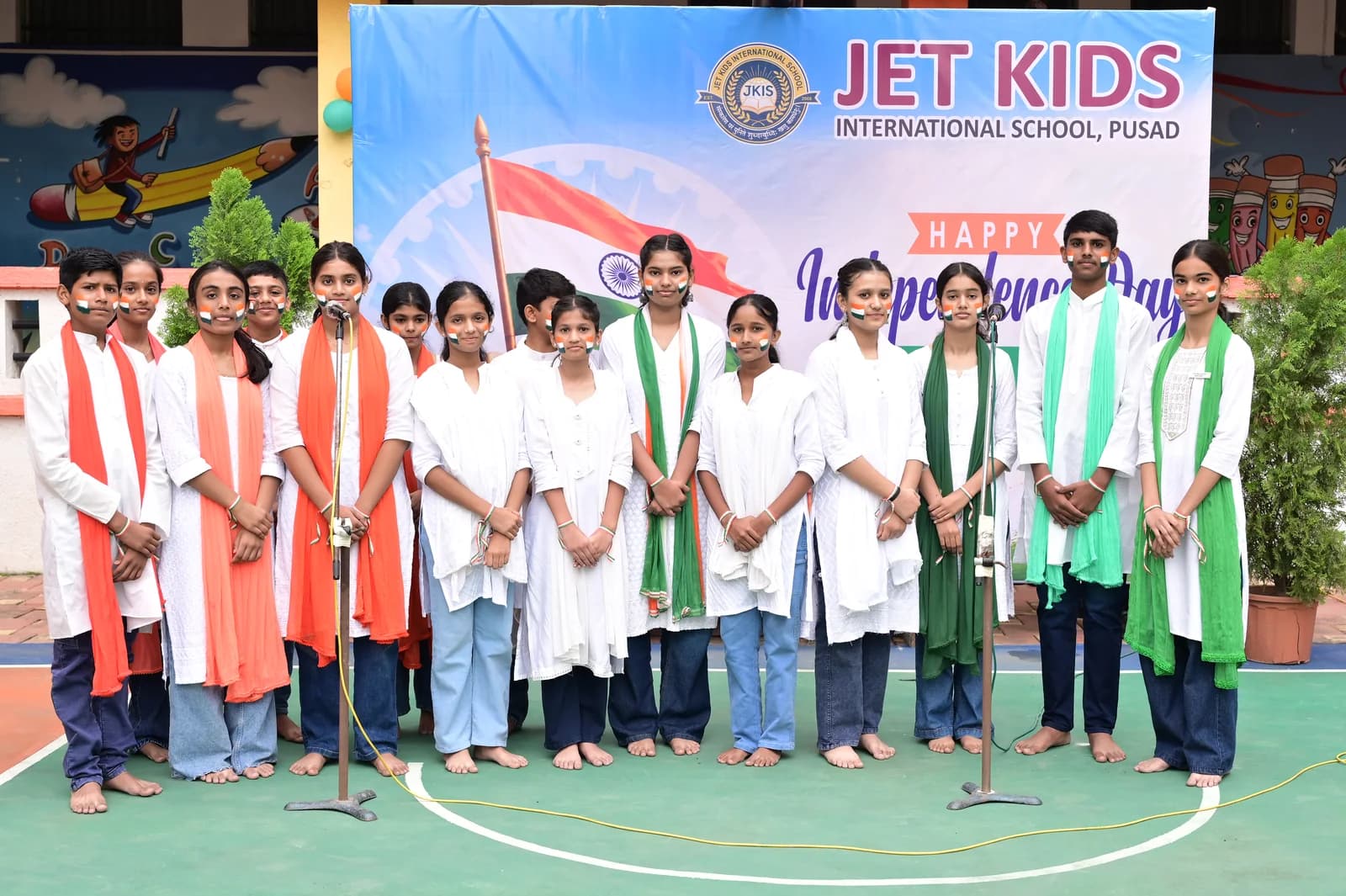 Full school choir in tricolour sashes