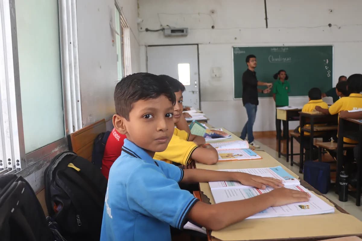 Primary school students collaborating on a structured classroom activity with their teacher